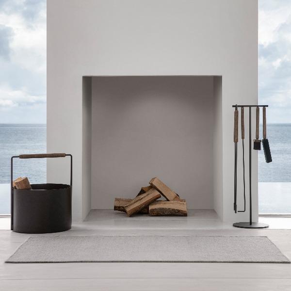 chic oceanside fireplace with modern tool set from ASHI collection by blomus