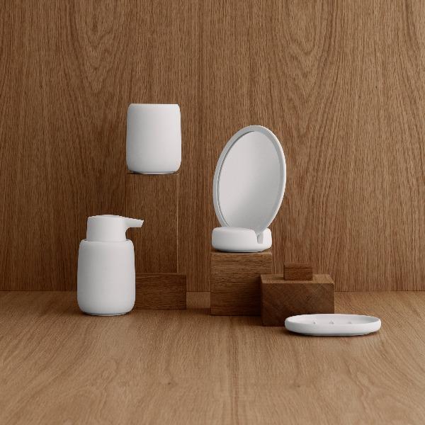 modern simplistic bath accessories showcased in a wooden room on wooden blocks
