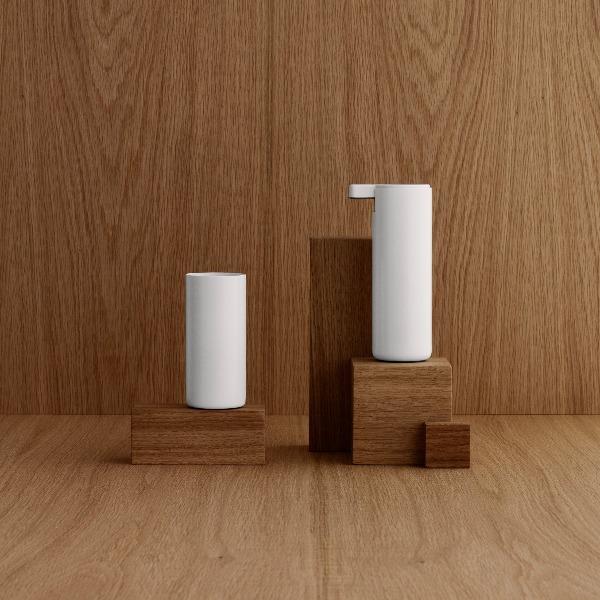 metal bathroom set with sleek white finish displayed upon wooden blocks
