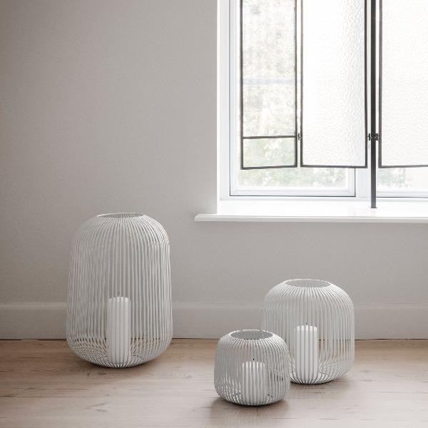 three sizes of white metal slat LITO lanterns on a modern wood floor