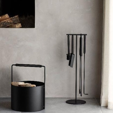 modern fireplace decor with blomus ASHI tool set and wood basket in a minimalist styled house