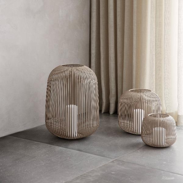 blomus LITO decorative lantern near a floor length curtain on large marble tiles