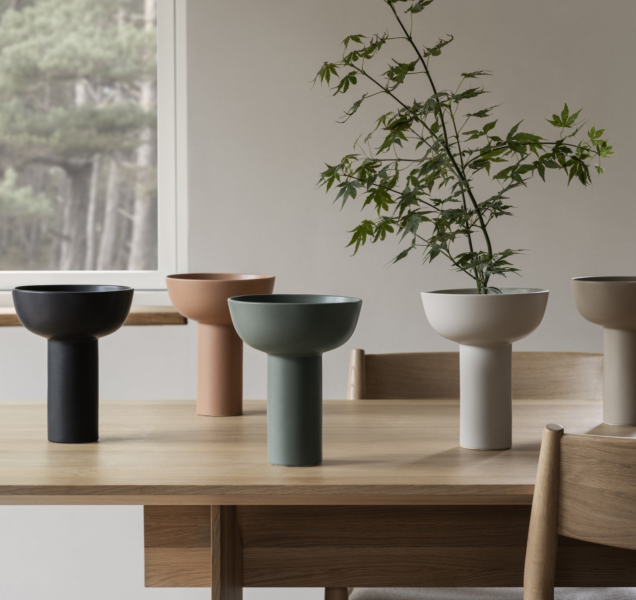elegant MIYABI vases displayed in all available colors on a wood dining table