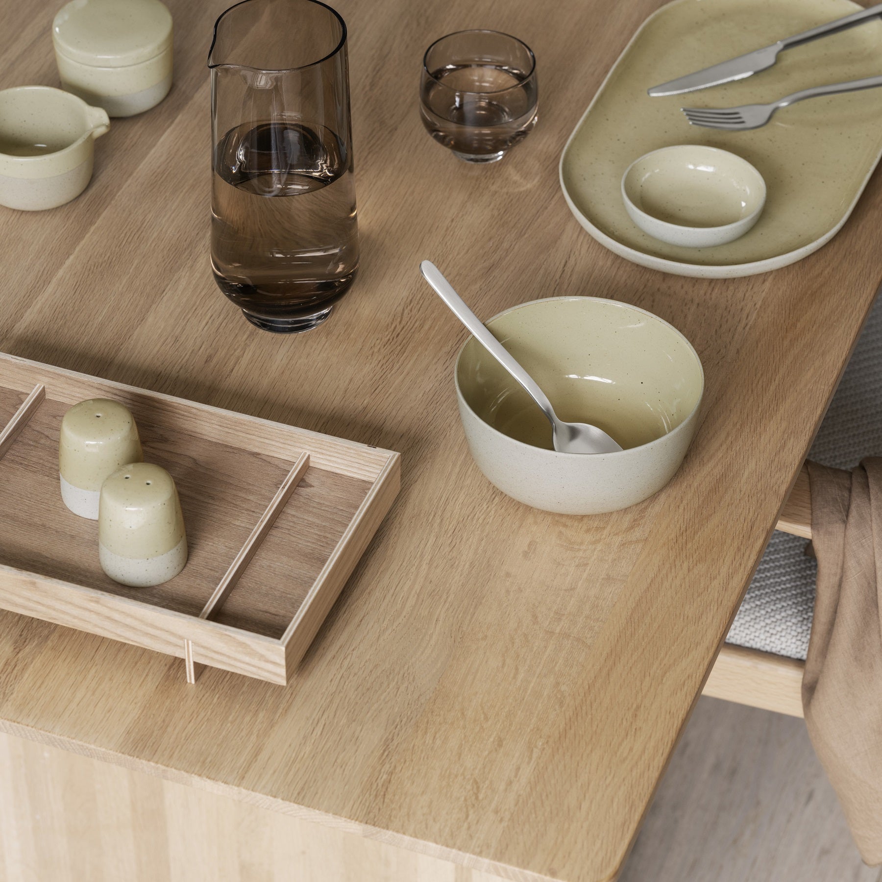 SABLO minimalist stoneware by blomus arranged on modern wooden dining table with STELLA cutlery for chic dining