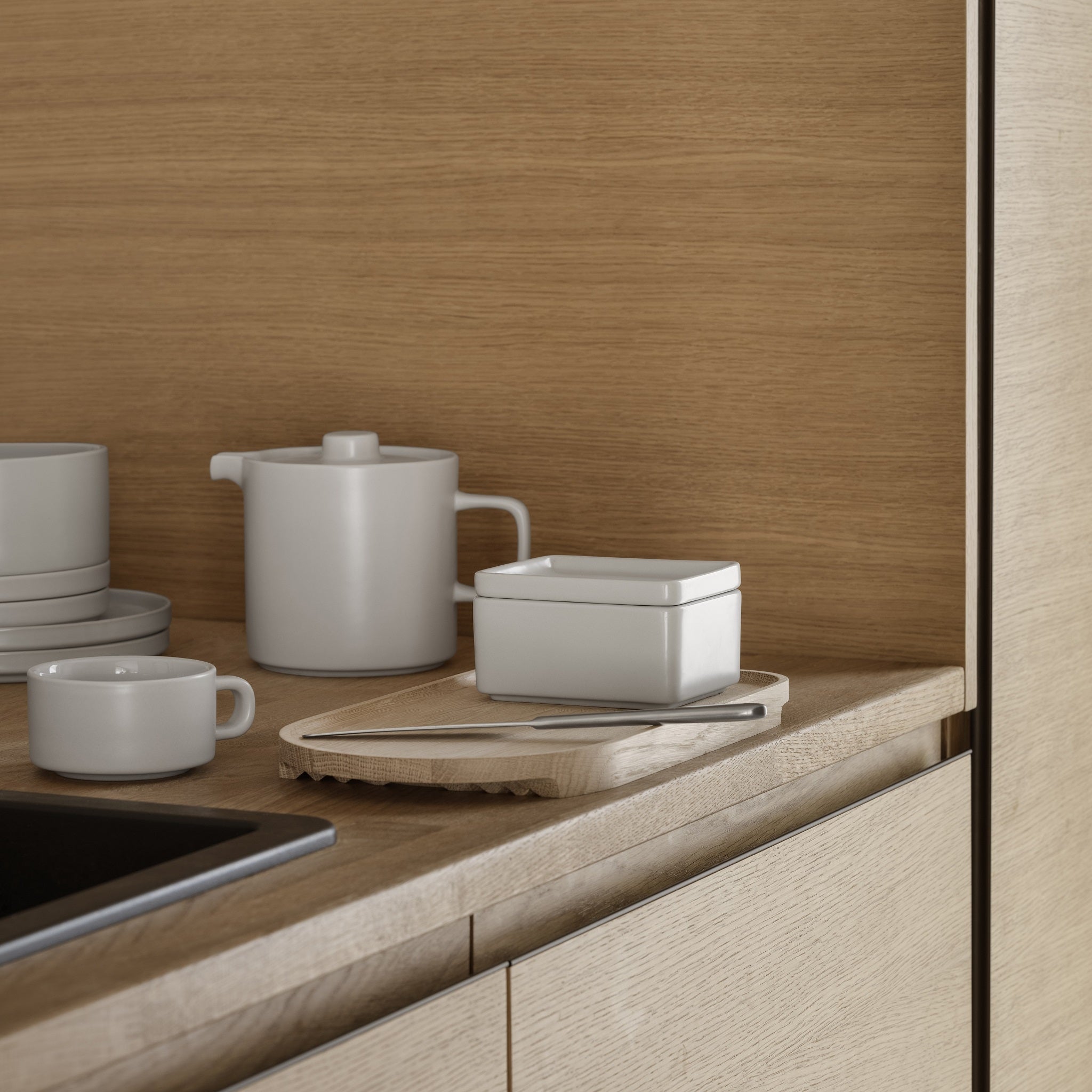 Scandinavian inspired butter dish from the blomus PILAR collection of stoneware placed upon a wooden countertop