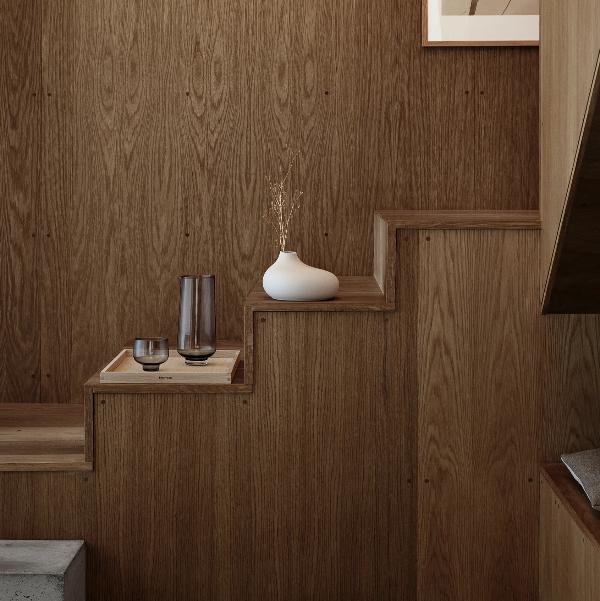 Wooden staircase shelves with modern porcelain vase by blomus