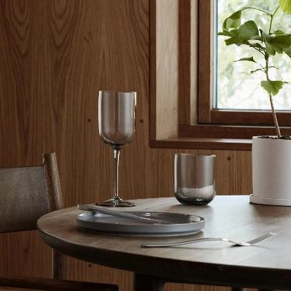elegant dinner table with NONA herb pot positioned in front of window with natural wood trim