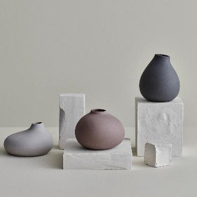 set of 3 NONA vases by blomus displayed on white stone blocks against a simple background