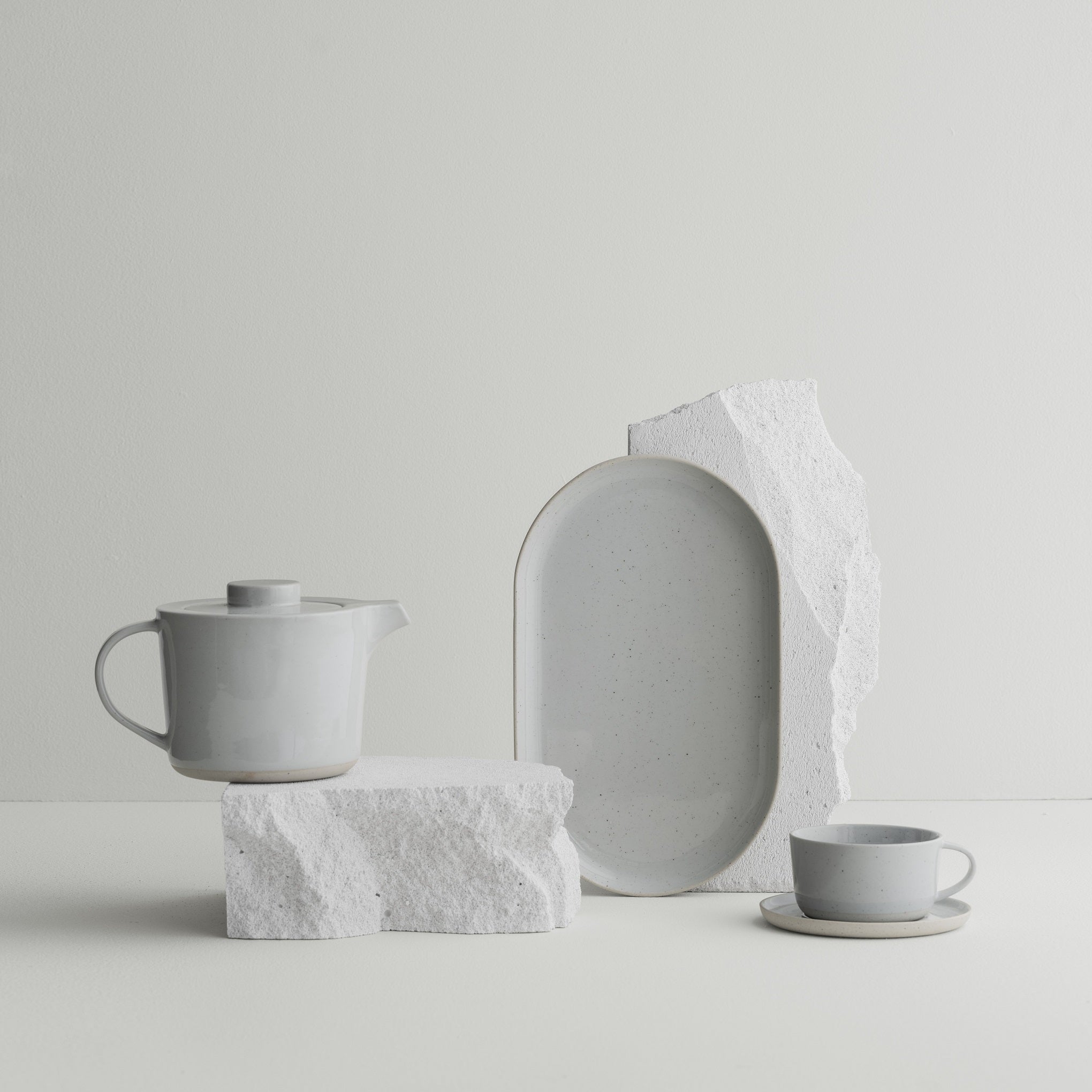 SABLO stoneware teapot by blomus arranged on granite with plate and cup