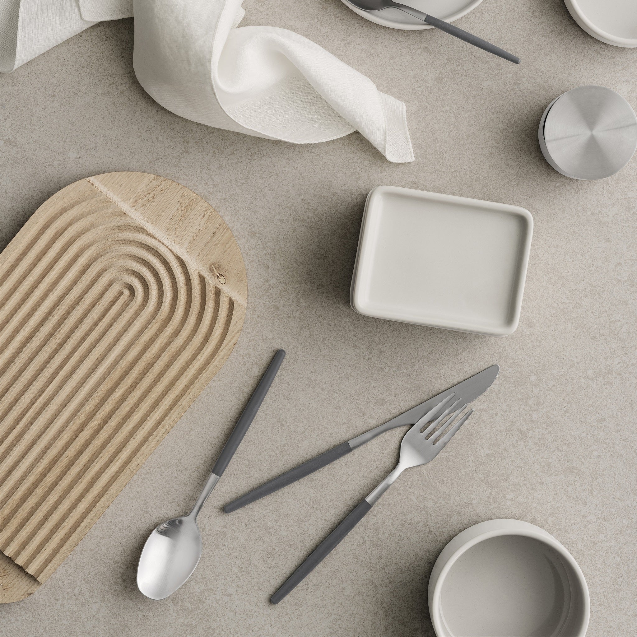 European designed PILAR ceramic Butter Dish casually arranged with a blomus cutting board and eating utensils