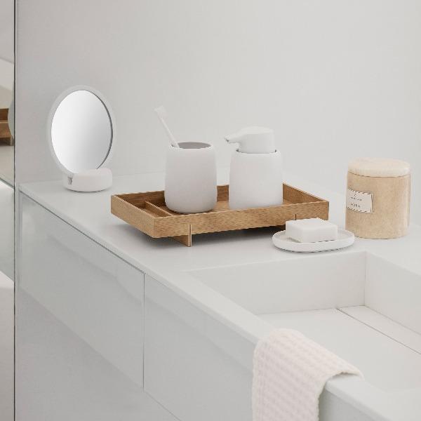 modern minimalist bathroom with simple white soap dispenser and toothbrush cup set