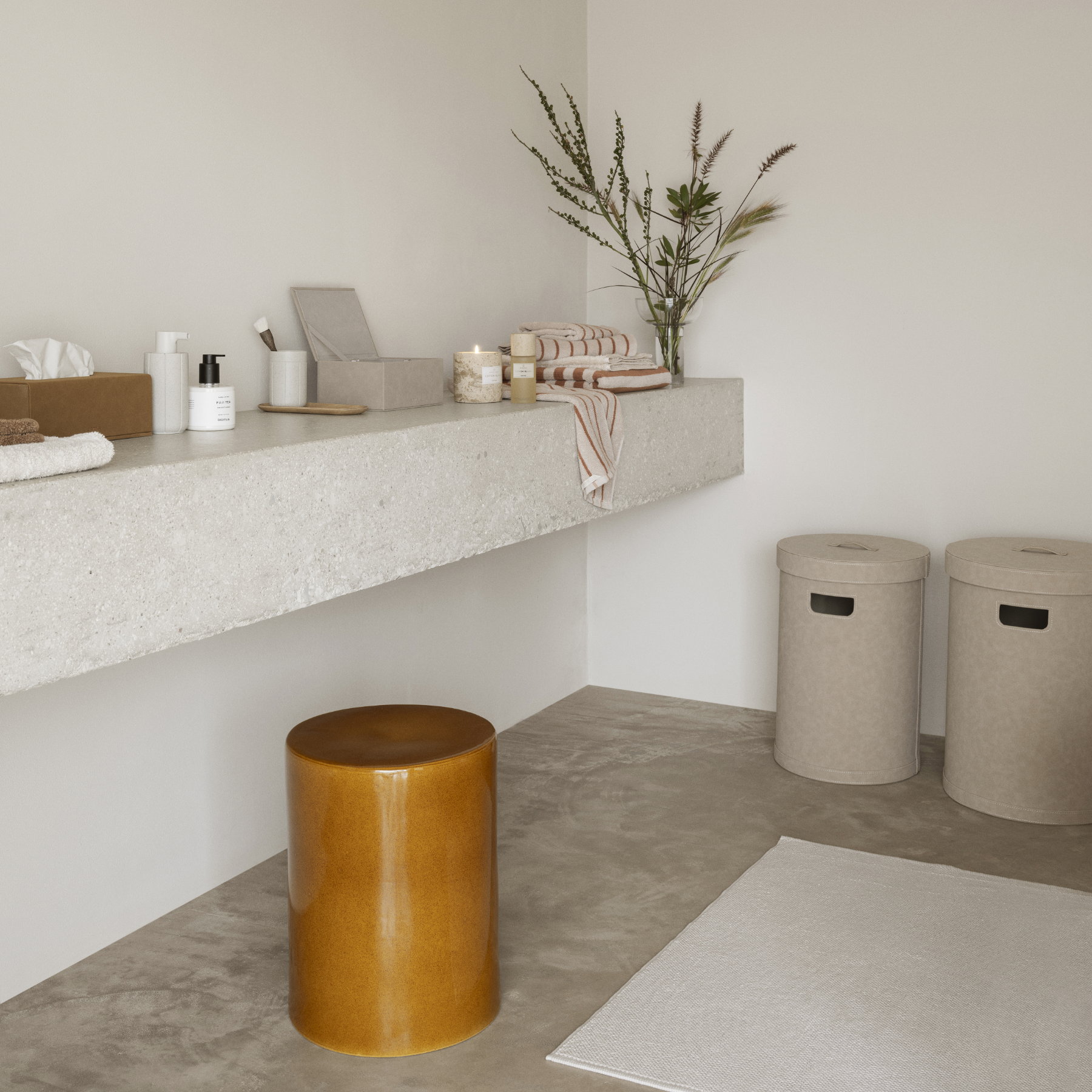 Minimalist bathroom counter shown with blomus KUA soap dispenser and tumbler, blomus SAHLA Jewelry Box and Tissue Box and BAKI Tray all sitting atop.