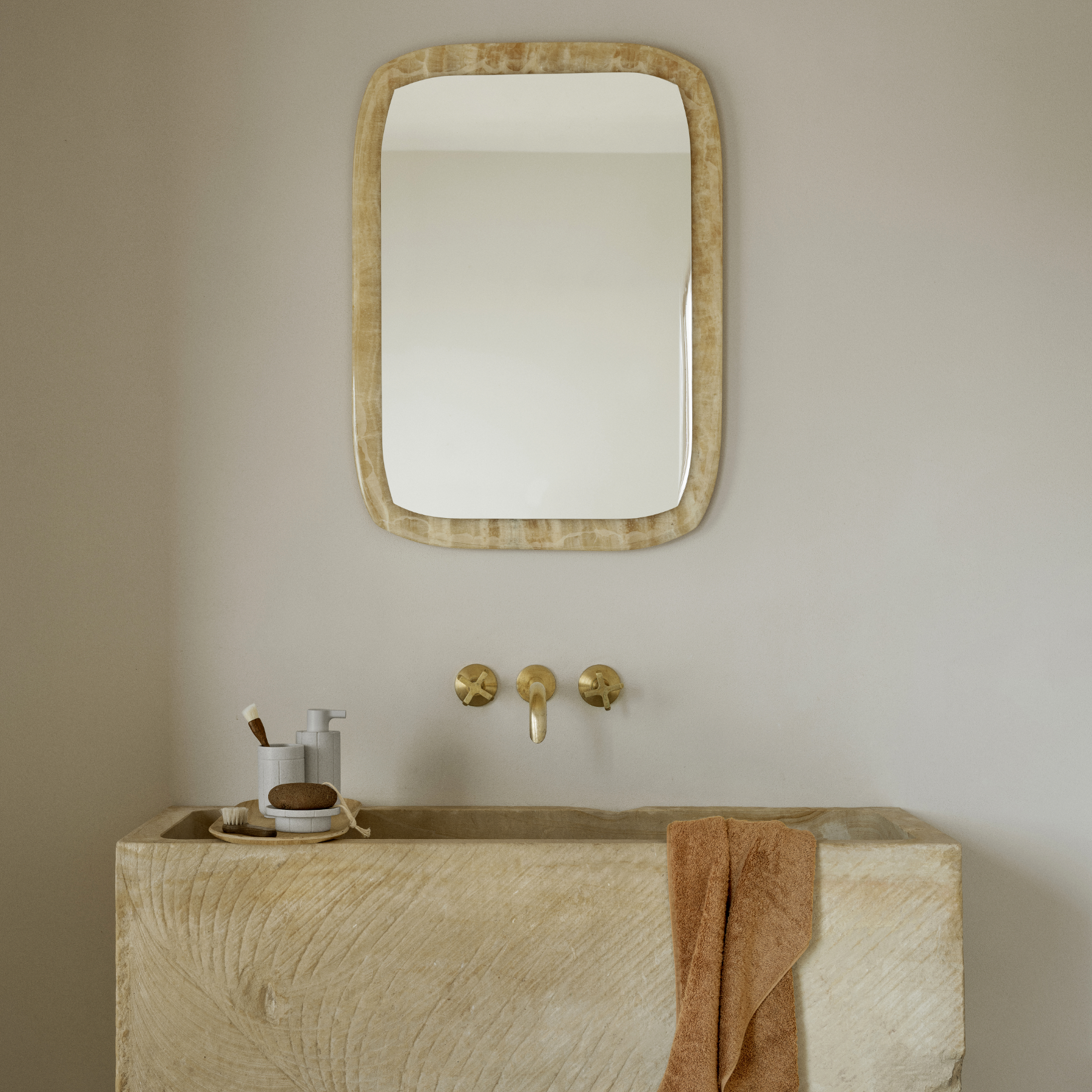 KUA Soap Dispenser, Tumbler and Tray on a BAKI Oak Tray in a on a modern sink with mirror, and gold fixtures.