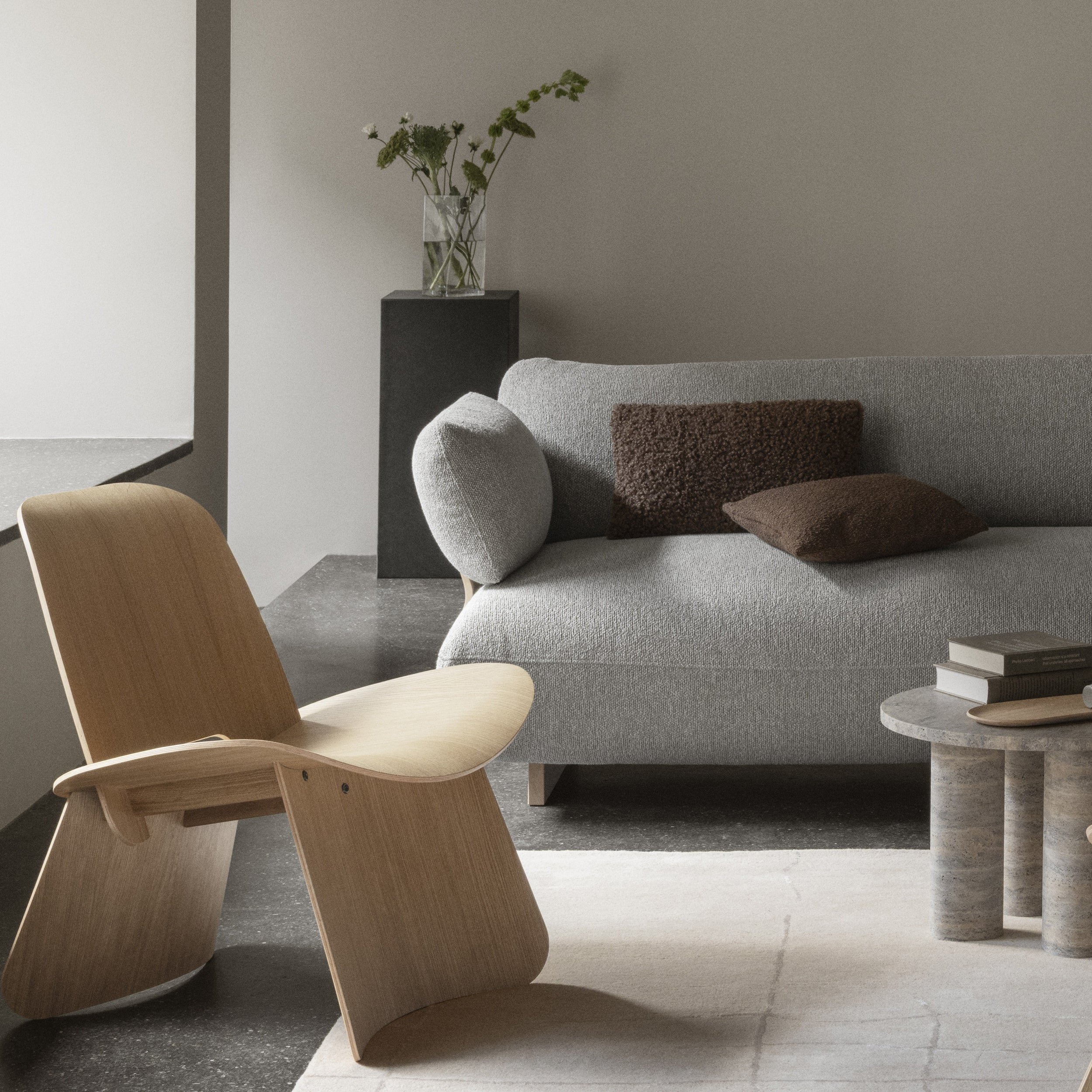 DUASA Clear Glass Vase on a pillar table with a couch and chair in front showing a modern living room setting