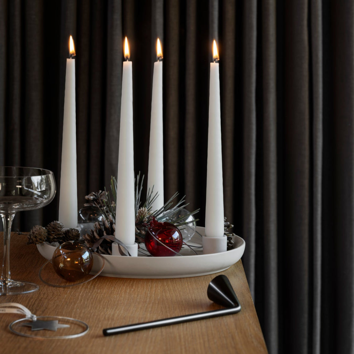 VELA stoneware candle holder with holiday ornaments and pine cones for a Scandinavian Christmas scene