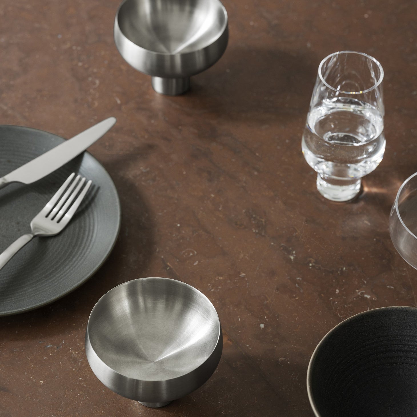 blomus KOYOI stainless steel champagne coupe on a minimalist dining table