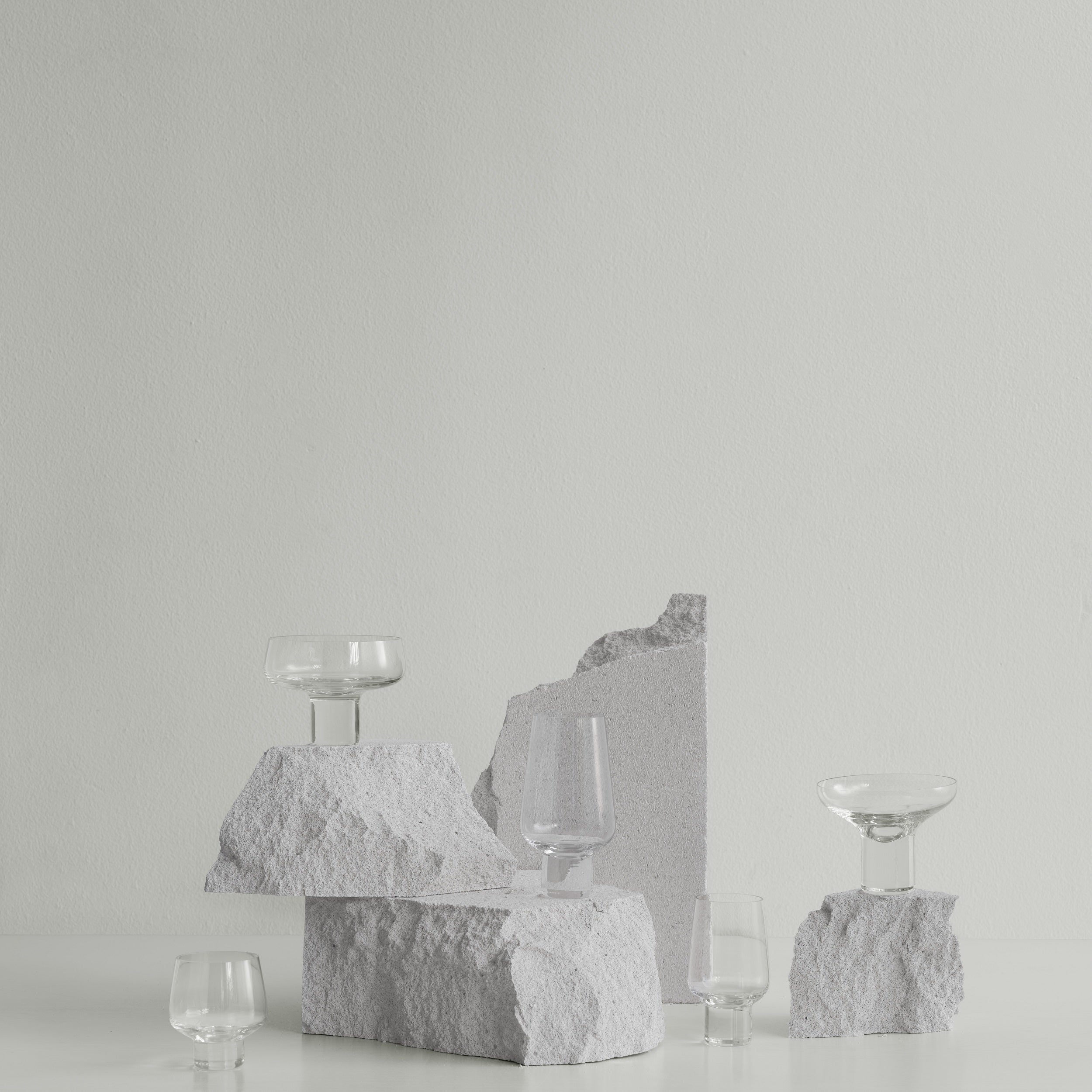 minimalist arrangement featuring KOYOI handblown Prosecco glass with pedestal stem along with other barware from blomus