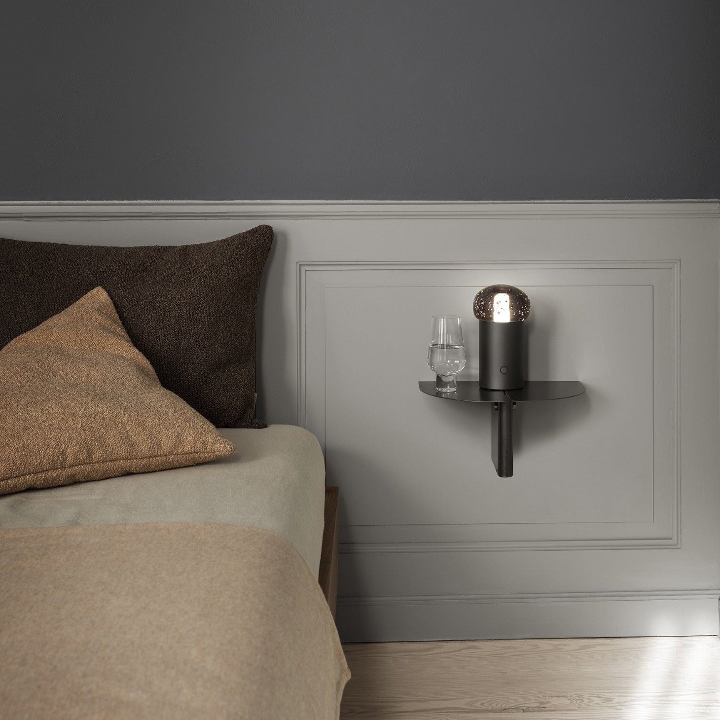 blomus ORU simple metal shelf next to bed in a minimalist bedroom