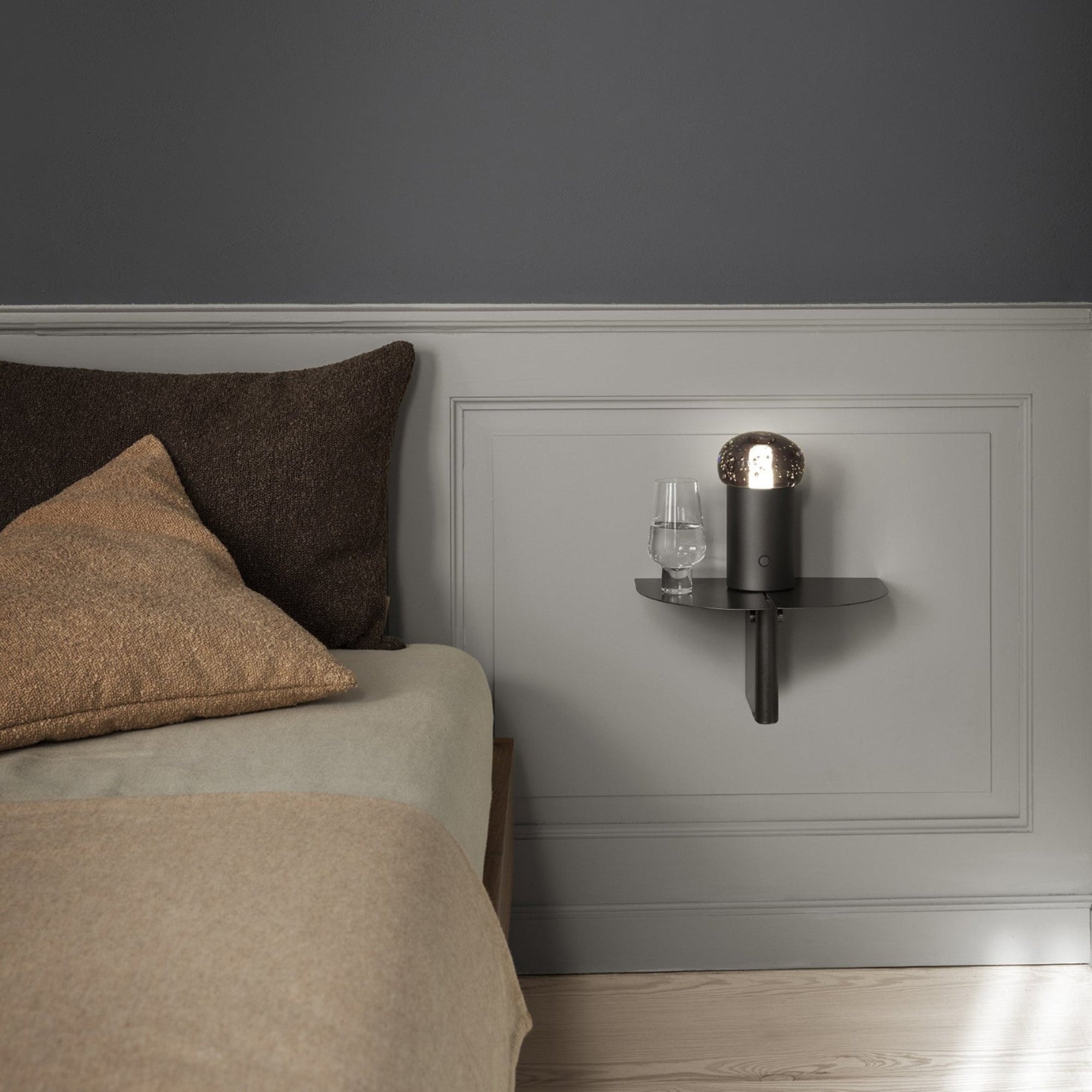 blomus ORU simple metal shelf next to bed in a minimalist bedroom