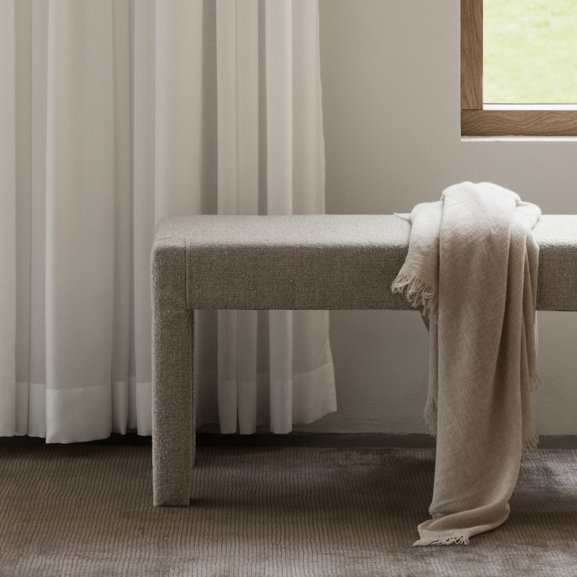 ottoman bench on a hand loomed viscose rug by blomus
