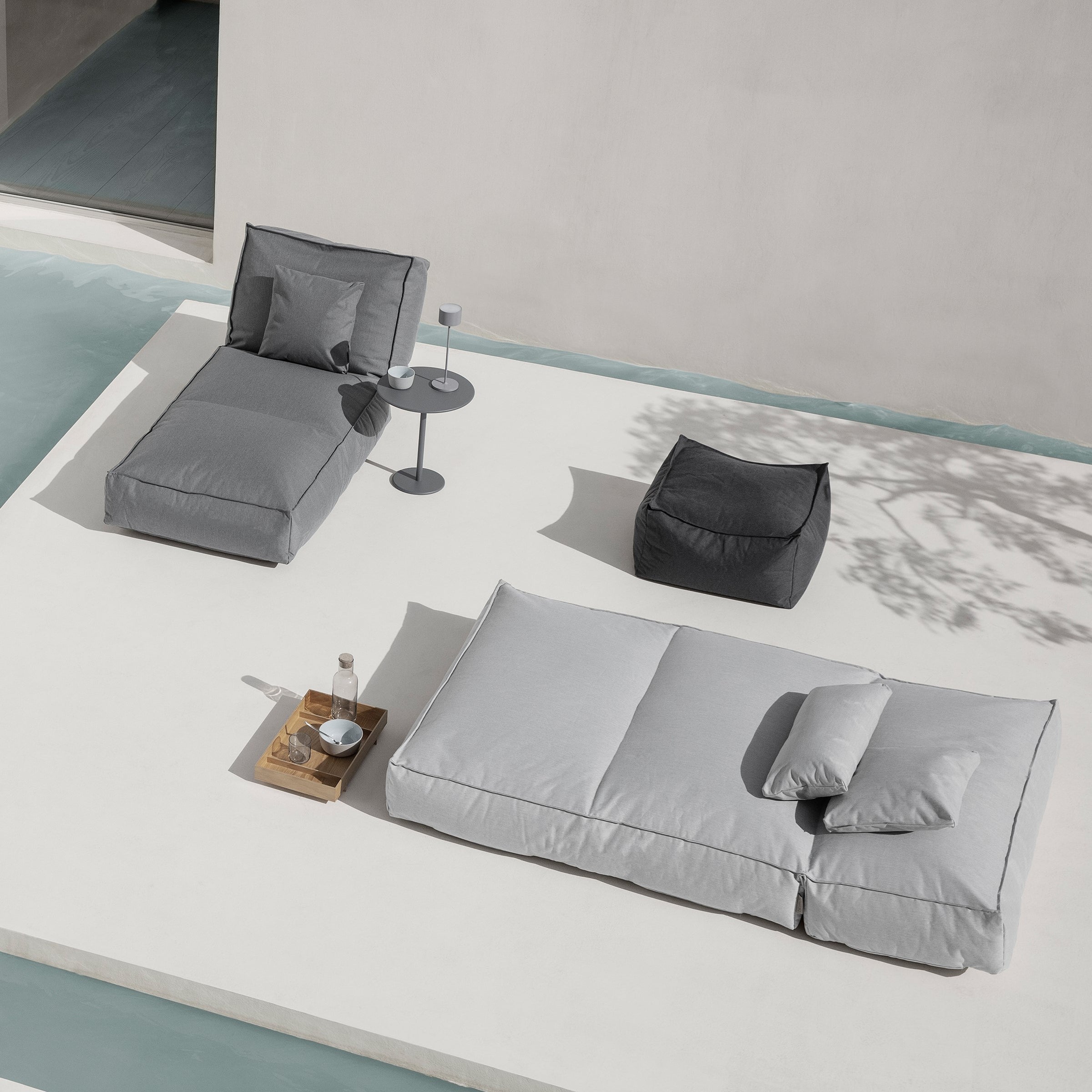 Outdoor lounging area with gray cushions