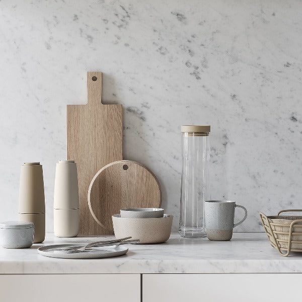 blomus BORDA oak cutting boards leaning against a marble backsplash for the modern kitchen