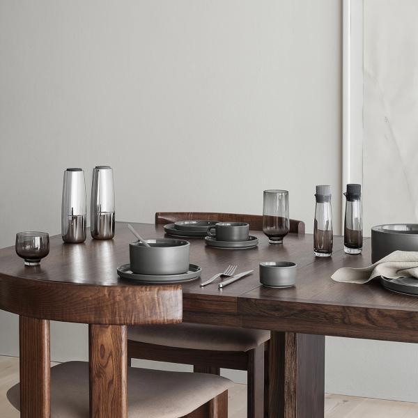modern walnut table set for a casual meal with blomus PILAR German designed stoneware