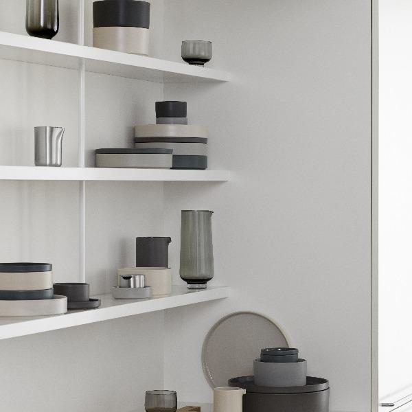 blomus PILAR stoneware arranged on simple modern white shelves displaying its matte exterior and multiple color options