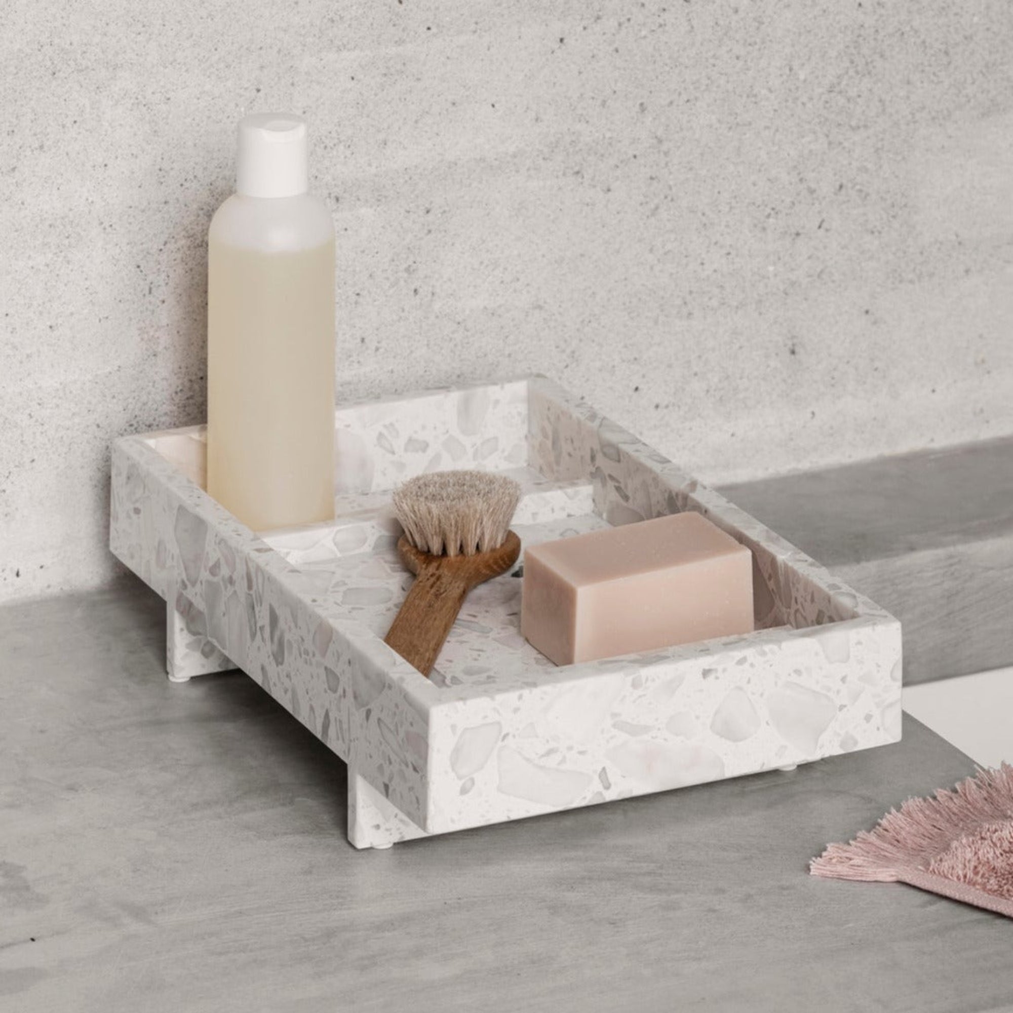 ABENTO marble tray holding bath items in a contemporary industrial design home 