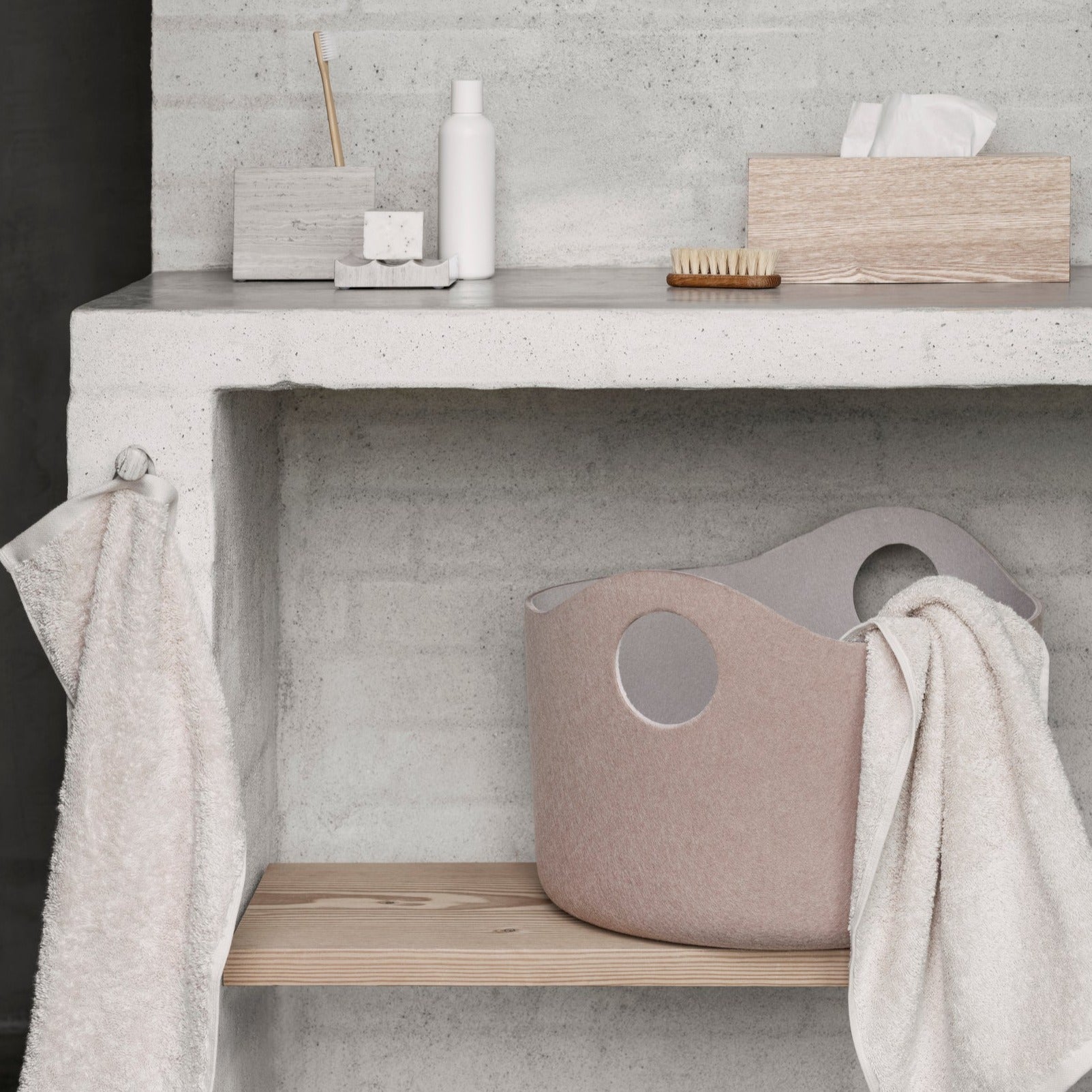 blomus TIGGY felt storage basket on a shelf in a modern industrial feel bathroom