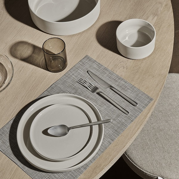 brightly lit dining table place setting showcasing the glazed interior of blomus PILAR stoneware