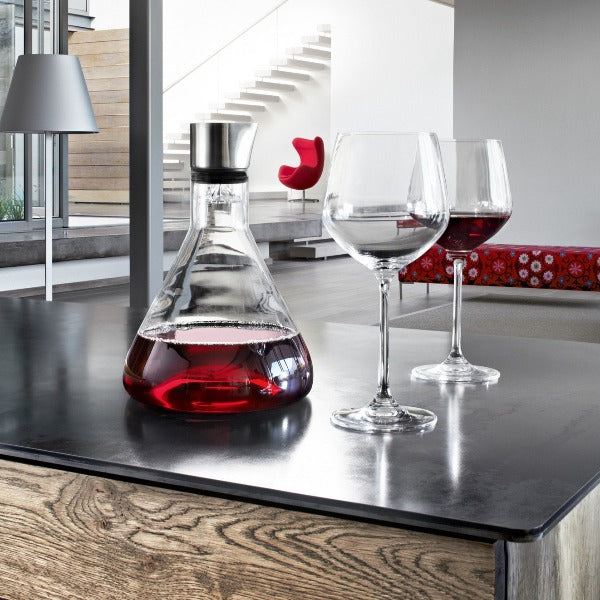 Posh kitchen scene with blomus DELTA wine decanter displayed on a chic black  island counter