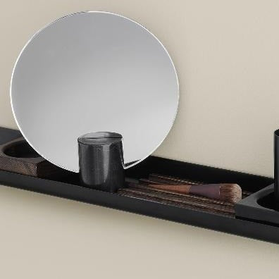 Wood tray organizer on metal blomus shelf holding bathroom items and a mirror