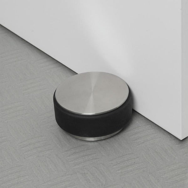 textured floor with STOP weighted stainless doorstop by blomus