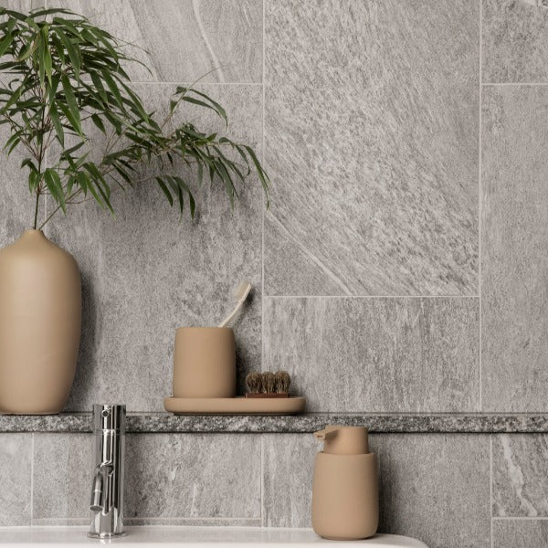 modern bathroom accessory set with matte finish displayed in front of an elegant marble wall