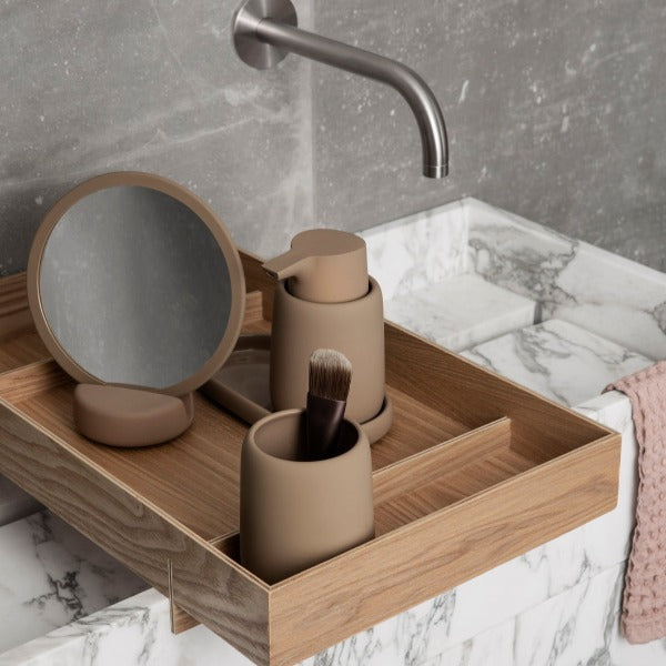 blomus SONO ceramic soap dispenser on a wooden tray over a marble sink