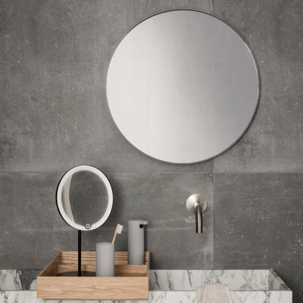 Industrial Modern bathroom setting with simple light grey soap dispenser and tumbler