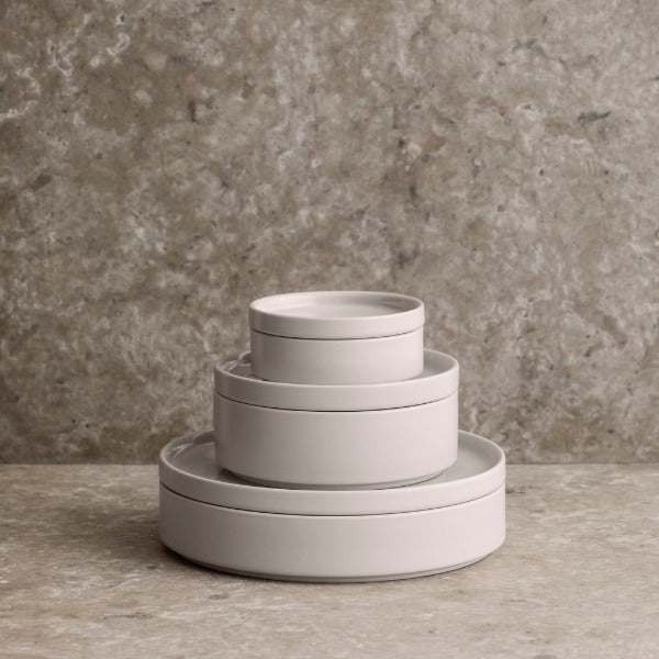 Stackable PILAR stoneware bowls and plates in microwave safe moonbeam cream finish