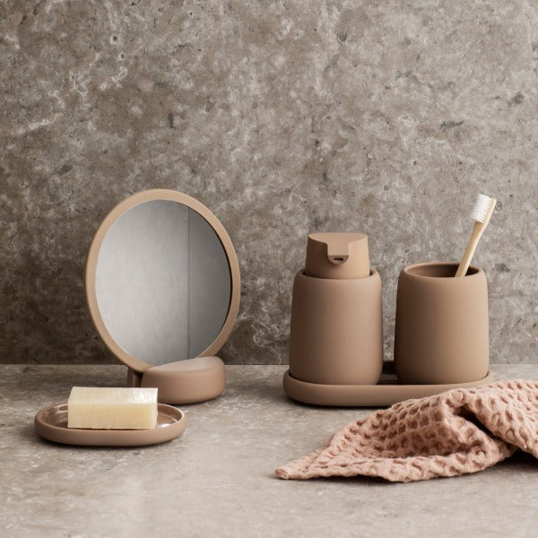 marble wall and counter highlighting Scandinavian design bathroom accessory set by blomus