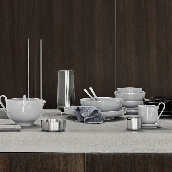 DELARA wire bread basket displayed casually with a set of porcelain dishes