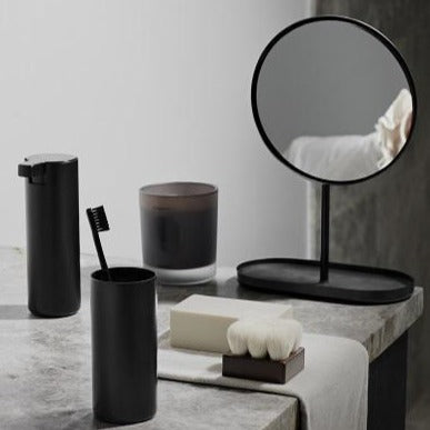 Elegant black metal bathroom accessories on a marble countertop