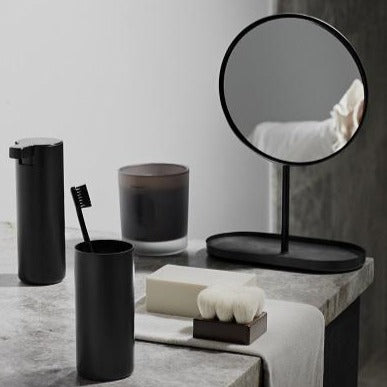 Marble countertop with simplistic black cosmetic mirror and other bathroom accessories from blomus 
