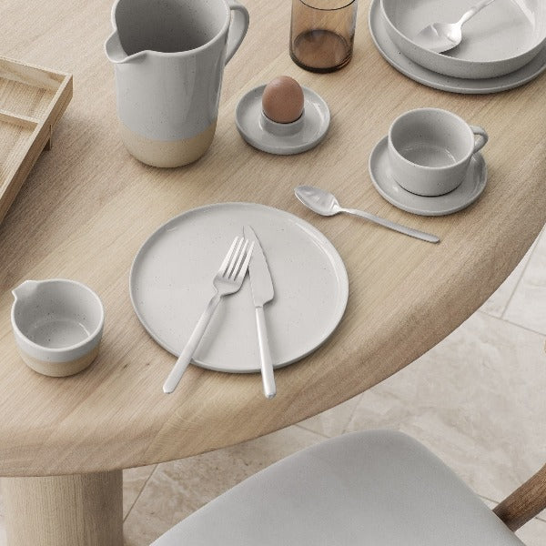 modern dining table setting featuring blomus STELLA flatware displayed on a plate with a minimalist aesthetic