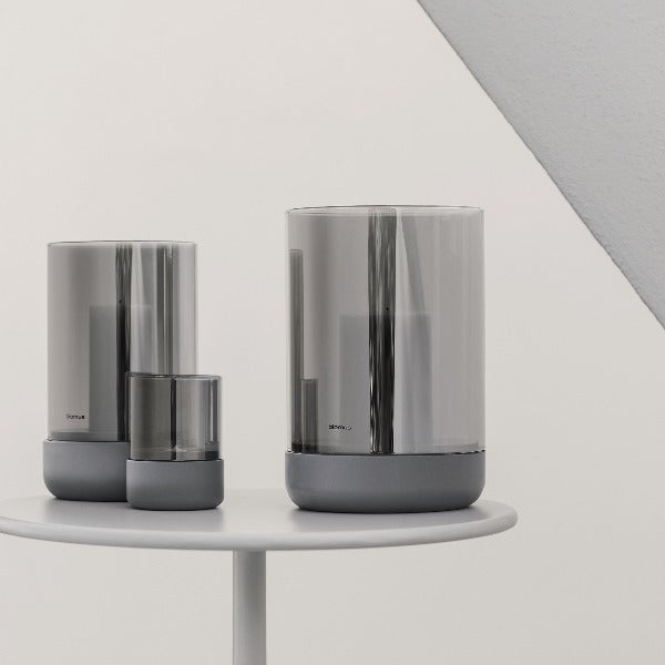 Three sizes of CALMA Hurricane lamp with mirrored glass on a round table