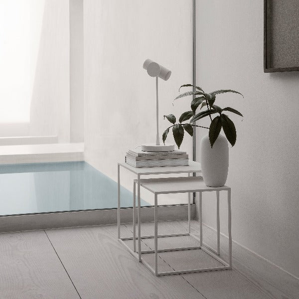 FERA white powder coated steel nesting tables in a chic modern bathing area