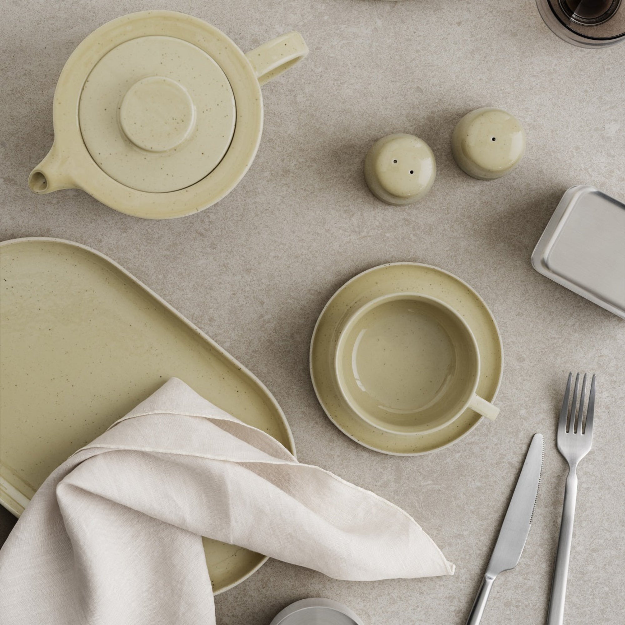 minimalist blomus SABLO stoneware salt and pepper shakers arranged on a table with teapot and cup and saucer