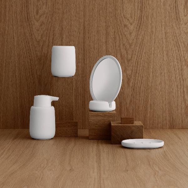 ceramic bathroom accessories with matte silicone coating in a wooden room